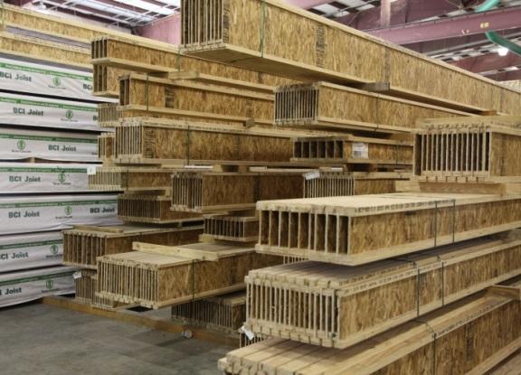 Stacks of engineered wood I-joists inside a Boise Cascade facility.