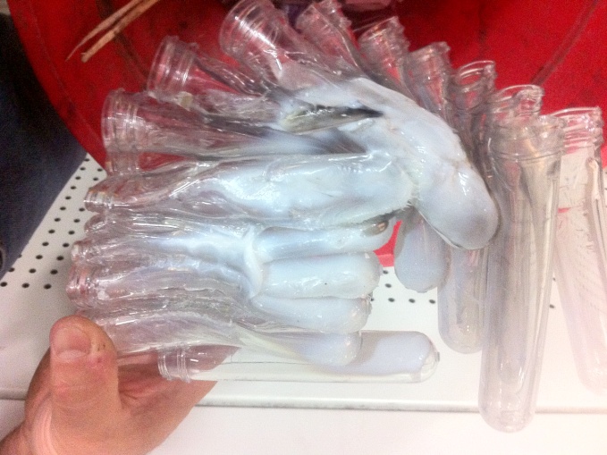 A cluster of melted plastic preforms recovered after an oven crash.