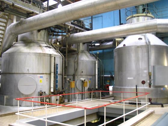 Large stainless-steel process vessels and connecting pipework in a sugar factory.